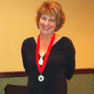 Kim Kluxen Meredith wins Silver Medal for Listen for the Whispers